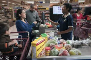 Woman at the checkout line in a grocery store